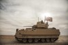 FILE - American soldiers drive a Bradley fighting vehicle during a joint exercise with Syrian Democratic Forces at the countryside of Deir Ezzor in northeastern Syria, Dec. 8, 2021. President Joe Biden said on Jan. 4, 2023, that's he's weighing sending Bradley Fighting Vehicles to help Ukraine in its effort to combat Russia's ongoing invasion. (AP Photo/Baderkhan Ahmad, File)