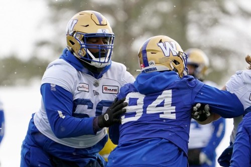 Winnipeg Blue Bombers offensive lineman Stanley Bryant (66) and defensive end Jackson Jeffcoat (94) battle for position during Grey Cup team practice in Regina, Friday, Nov. 18, 2022. The CFL's outstanding lineman last season signed a one-year extension with the Winnipeg Blue Bombers on Thursday. THE CANADIAN PRESS/Heywood Yu