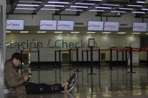 A passenger waits in an empty terminal at the airport while flights are suspended due to drug cartel-related violence in Culiacan, Sinaloa state, Mexico on January 6, 2023. THE CANADIAN PRESS/AP, Martin Urista