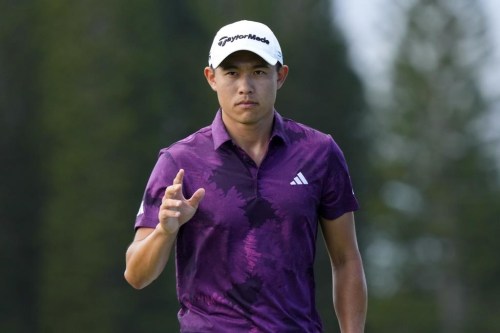 Collin Morikawa acknowledges the gallery after making his birdie putt on the ninth green during the third round of the Tournament of Champions golf event, Saturday, Jan. 7, 2023, at Kapalua Plantation Course in Kapalua, Hawaii. (AP Photo/Matt York)