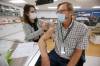 Dr. Brian Penner, internal medicine, Health Sciences Centre, receives the first COVID-19 inoculation in Manitoba from public health nurse LoriAnn Laramee on Dec. 16, 2020. (John Woods / The Canadian Press files)