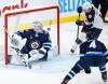 Columbus Blue Jackets&rsquo; Gustav Nyquist (14) scores on Winnipeg Jets goaltender David Rittich (33) as Neal Pionk (4) defends during the second period. (The Canadian Press / John Woods)