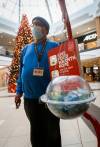 Volunteer Darryl Peacock gives his time to man the Salvation Army Christmas fundraising kettle at Polo Park on Tuesday. Donations to date are only one-third of the $385,000 the Salvation Army is aiming for. (John Woods / Winnipeg Free Press)