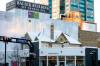 MIKAELA MACKENZIE / WINNIPEG FREE PRESS
                                A peaked roof pokes out above storefronts, a vestige of another time, at Kennedy Street and Graham Avenue in Winnipeg.