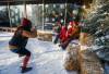 JOHN WOODS / WINNIPEG FREE PRESS
                                Helene Le Moullec, an employee at the Gas Station Arts Centre, takes a photo of Shannon and Ross and their child Beckett as they visit with Santa at the Winter in the Village festival outside the Gas Station Arts Centre in Osborne Village.