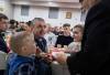 JESSICA LEE / WINNIPEG FREE PRESS
                                Liubomyr Zelenko (in black) is presented with communion bread. He celebrates Ukrainian Christmas Eve with his family Sviatoslav, 5, and Mariia, 18 (right) on Friday at Sts.Vladimir and Olga Cathedral.