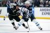 Winnipeg Jets defenseman Josh Morrissey, right, moves the puck as Los Angeles Kings center Blake Lizotte reaches for it during the first period of an NHL hockey game Thursday, Oct. 27, 2022, in Los Angeles. (AP Photo/Mark J. Terrill)