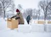 Owen Swendrowski-Yerex packs snow into boxes to build a fort at St. John&rsquo;s Park last week. (Jessica Lee / Winnipeg Free Press)