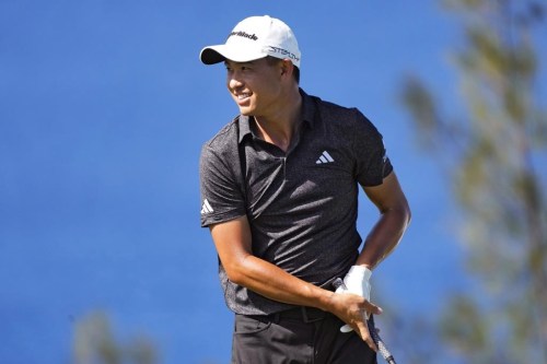 Collin Morikawa smiles after his shot from the 13th tee during the final round of the Tournament of Champions golf event, Sunday, Jan. 8, 2023, at Kapalua Plantation Course in Kapalua, Hawaii. (AP Photo/Matt York)