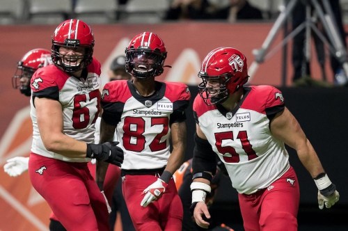 Calgary Stampeders' Zack Williams (67), Malik Henry (82) and Sean McEwen (51) celebrate Henry's touchdown against the B.C. Lions during the second half of a CFL football game in Vancouver, on Friday, November 12, 2021. Canadian offensive lineman Williams signed a two-year contract extension with the Calgary Stampeders on Monday. Williams, a 2019 third-round CFL draft pick, was eligible to become a free agent next month. THE CANADIAN PRESS/Darryl Dyck