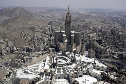 FILE - An aerial view shows the clock tower over the Grand mosque as Muslim pilgrims walk around the Kaaba, the black cube seen at center inside the grand mosque, during the annual hajj pilgrimage in Mecca, Saudi Arabia, on July 10, 2022. Islam's annual hajj pilgrimage in Saudi Arabia will return to pre-pandemic levels in 2023, after restrictions saw the annual religious commemoration curtailed over concerns about the coronavirus, authorities say. (AP Photo/Amr Nabil, File)