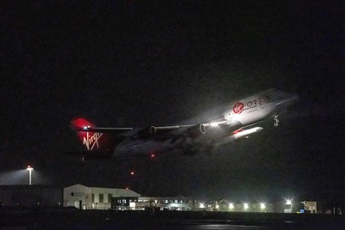 A repurposed Virgin Atlantic Boeing 747 aircraft, named Cosmic Girl, carrying Virgin Orbit's LauncherOne rocket, takes off from Spaceport Cornwall at Cornwall Airport, Newquay, England, Monday, Jan. 9, 2023. The plane will carry the rocket to 35,000 feet where it will be released over the Atlantic Ocean to the south of Ireland, as part of the Start Me Up mission and the first rocket launch from U.K. The rocket will take multiple small satellites, with a variety of civil and defence applications, into orbit. (Ben Birchall/PA via AP)