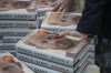 Members of staff place the copies of the new book by Prince Harry called 