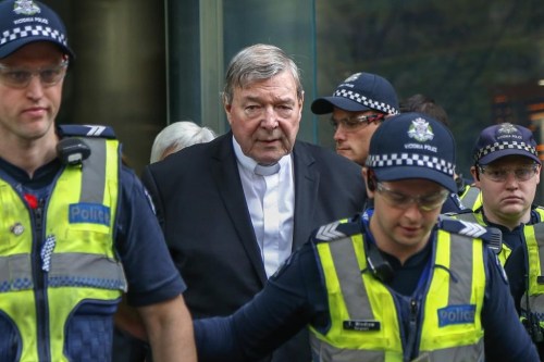 FILE - Cardinal George Pell, center, the most senior Catholic cleric to face sex charges, leaves court in Melbourne, Australia, May 2, 2018. Pell, who was the most senior Catholic cleric to be convicted of child sex abuse before his convictions were later overturned, has died Tuesday, Jan. 10, 2023, in Rome at age 81. (AP Photo/Asanka Brendon Ratnayake, File)