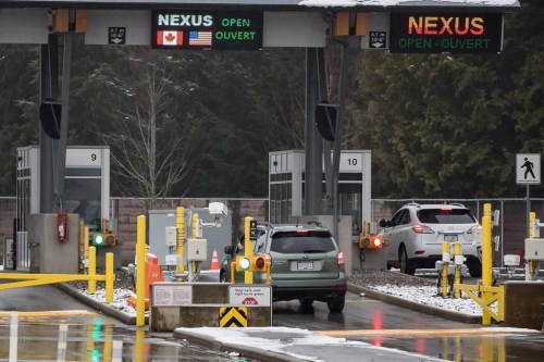 A motorist scans a Nexus card as another speaks with a Canada Border Services Agency officer at a primary inspection booth at the Douglas-Peace Arch border crossing in Surrey, B.C., on Wednesday February 5, 2020. Canadian and U.S. border agencies say they have a plan to reduce the backlog for the Nexus trusted-traveller program. THE CANADIAN PRESS/Darryl Dyck