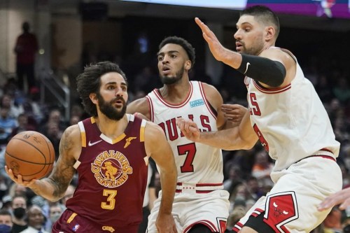 FILE -Cleveland Cavaliers' Ricky Rubio (3) drives against Chicago Bulls' Troy Brown Jr. (7) and Nikola Vucevic (9) in the second half of an NBA basketball game, Wednesday, Dec. 8, 2021, in Cleveland. More than a year after tearing a knee ligament and underdoing surgery, Rubio is expected to make his debut Thursday, Jan. 12, 2023 when Cleveland visits the Portland Trail Blazers. (AP Photo/Tony Dejak, File)