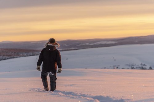 FILE - Reindeer herder Niila Inga from the Laevas Sami community walks across the snow as the sun sets on Longastunturi mountain near Kiruna, Sweden, on Nov. 27, 2019. A Swedish government-owned iron ore mining company says it has identified “significant deposits” of rare earth elements in Arctic Sweden that are essential for the manufacture of electric vehicles and wind turbines. LKAB's CEO said the quantity of rare earth metals exceeds 1 million tons and is the largest known deposit of its kind in Europe. Sweden's Energy and Business Minister said 