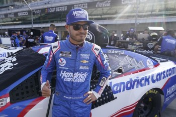 FILE - Kyle Larson waits for the start of qualifications for the NASCAR Series auto race at Indianapolis Motor Speedway, Sunday, Aug. 15, 2021, in Indianapolis. Kyle Larson will attempt to race the Indianapolis 500 in 2024 with McLaren Racing in a joint effort with NASCAR team owner Rick Hendrick. The surprise Thursday, Jan. 12, 2023, announcement by McLaren and Hendrick at last gives Larson a path into his dream race.(AP Photo/Darron Cummings, File)