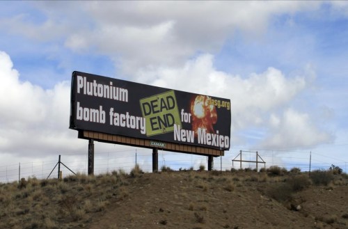 FILE - In this Feb. 17, 2021 file photo, The Los Alamos Study Group takes aim at the U.S. government's plans to ramp up production of plutonium cores for the nation's nuclear arsenal with this billboard near Bernalillo, N.M. The Government Accountability Office said in a report released Thursday, Jan. 12, 2023, that plans by the National Nuclear Security Administration for reestablishing plutonium pit production do not follow best practices and run the risk of delays and cost overruns. (AP Photo/Susan Montoya Bryan, File)