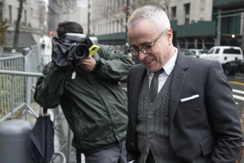 Fashion designer Thom Browne, right, arrives at Manhattan federal court in New York, Tuesday, Jan. 3, 2023. (AP Photo/Seth Wenig)