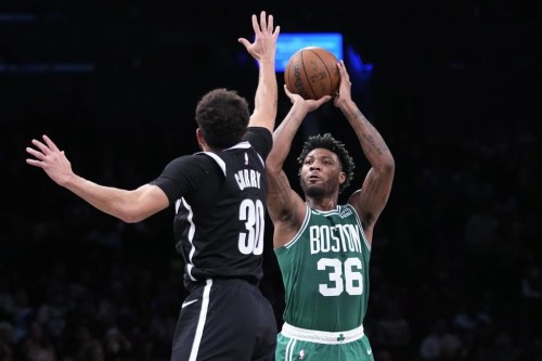 Boston Celtics guard Marcus Smart (36) shoots as Brooklyn Nets guard Seth Curry (30) defends during the first half of an NBA basketball game Thursday, Jan. 12, 2023, in New York. (AP Photo/Mary Altaffer)