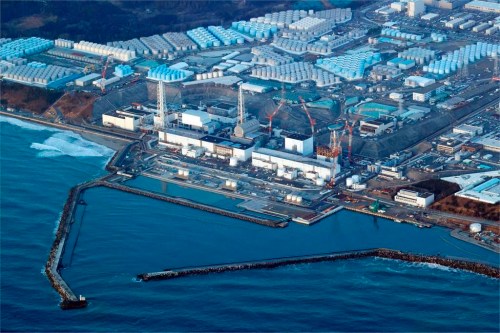 FILE - This aerial photo shows the Fukushima Daiichi nuclear power plant in Okuma town, Fukushima prefecture, north of Tokyo, on March 17, 2022. Japan's government has revised the timing of a planned release to the sea of treated but still radioactive wastewater at the Fukushima nuclear power plant to “around spring or summer,