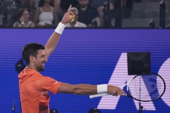 Serbia's Novak Djokovic gestures during an exhibition match against Australia's Nick Kyrgios on Rod Laver Arena ahead of the Australian Open tennis championship in Melbourne, Australia, Friday, Jan. 13, 2023. (AP Photo/Mark Baker)