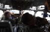 FILE - Pilots work in the cockpit of an AWACS plane at Melsbroek military airport in Melsbroek, Belgium, on Nov. 27, 2019. NATO is set to deploy three surveillance planes to Romania next week to perform reconnaissance missions to 