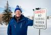 Mike Sudoma/Winnipeg Free Press Community member Wesley Wold stands next to a sign warning folks of all ages from sliding down a hill next to Whyte Ridge Elementary School because of “Hidden Hazards” February 10, 2023