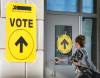 A woman enters Maple High School in Vaughan, Ont., to cast her vote in the Canadian federal election in 2015. (Peter Power / The Canadian Press files)