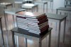 Books are piled onto a desk in an empty classroom at McGee Secondary school in Vancouver, B.C. Friday, Sept. 5, 2014. The Manitoba government is planning to bring back provincewide Grade 12 tests in English and math, starting next year. THE CANADIAN PRESS/Jonathan Hayward
