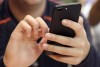 The voice you hear on the other end of your phone call may not be who you think it is, the person you're texting with may really be a bot and the face in a photo or video on your favourite dating app may not even exist. Technological advancements in artificial intelligence create the potential to fuel romance scams, said Jeff Clune, an associate professor of computer science at the University of British Columbia. A young person uses a smart phone in Chicago. THE CANADIAN PRESS/AP
