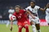 FILE - Canada's Christine Sinclair (12) and Trinidad and Tobago's Victoria Swift compete for the ball during a CONCACAF women's championship soccer match in Monterrey, Mexico, July 5, 2022. Players on the Canadian women's national team says they're outraged by cuts to the women's program and won't participate in team activities. “The time is now, we are taking job action,