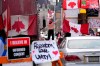 A protester dances on a barrier in front of vehicles and placards on Rideau Street, during a protest against COVID-19 measures, in Ottawa, on Wednesday, Feb. 16, 2022. The Public Order Emergency Commission says Ontario abandoned the people of Ottawa. Justice Paul Rouleau has found that Ontario's reluctance to be fully engaged with the federal government and the City of Ottawa to be troubling. THE CANADIAN PRESS/Justin Tang