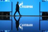 A man walks at an exhibition at the St. Petersburg International Gas Forum in St. Petersburg, Russia, Wednesday, Sept. 14, 2022, with a logo of Russian gas monopoly Gazprom in the background. Canada's trade with Russia plummeted in the first 10 months after Moscow's invasion of Ukraine a year ago, with Ottawa's economic measures barring the export of everything from forklifts to barbers' chairs. THE CANADIAN PRESS/AP-Dmitri Lovetsky