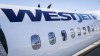 A WestJet plane waits at a gate at Calgary International Airport in Calgary, Alta., Wednesday, Aug. 31, 2022.&nbsp;WestJet customers say they were rebooked on a seven-and-a-half-hour bus trip from Calgary to Regina after their flight was cancelled Sunday. THE CANADIAN PRESS/Jeff McIntosh