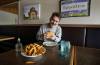 RUTH BONNEVILLE / WINNIPEG FREE PRESS
                                Richard Caron, who runs the Instagram account, For the Love of All Fat Boys, taste-tests a fat boy hamburger at Original George&rsquo;s Burgers & Subs on St. Mary&rsquo;s Road.