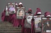 Activists hold placards reading 