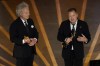 Charlie Mackesy, left, and Matthew Freud accept the award for best animated short for 
