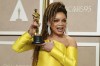 Ruth E. Carter poses with the award for best costume design for 
