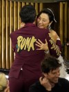 Daniel Kwan, left, is hugged in the audience by Michelle Yeoh as he accepts the award for best original screenplay for 