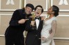 Ke Huy Quan, center, winner of the award for best performance by an actor in a supporting role for 