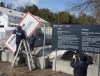 Workers remove warning signs at the irregular border at Roxham Road from New York into Canada on Friday, March 24, 2023, in Champlain, N.Y. THE CANADIAN PRESS/Ryan Remiorz
