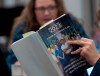 A reporter reads a copy of the Federal Budget in the lockup for the Federal budget, Tuesday, March 28, 2023 in Ottawa. THE CANADIAN PRESS/Adrian Wyld