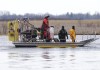 Searchers look for victims Friday, March 31, 2023, after a boat capsized and left eight people dead in Akwesasne, Que. Authorities investigating the disappearance of an Akwesasne man whose boat was found near the bodies of eight migrants pulled from the St. Lawrence River say he was connected to the case. THE CANADIAN PRESS/Ryan Remiorz