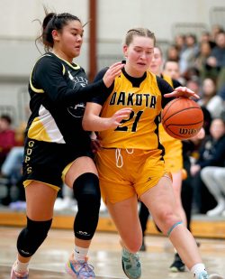 Garden City Gophers’ Halley Cruz (5) defends against Dakota Lancers’ Darya Rom (21).