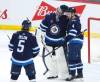 Winnipeg Jets defenceman Neal Pionk, right, celebrates a shutout win over the Nashville Predators with teammates Connor Hellebuyck and Brenden Dillon Saturday. THE CANADIAN PRESS/John Woods