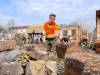 MELISSA MARTIN / WINNIPEG FREE PRESS 
                                University of Manitoba student William Lazarenko, 22, clears rubble from the ruins of Nataliya Sheynich&rsquo;s home, which was partly destroyed last year during battles in the Kyiv region of Ukraine. Lazarenko was volunteering with Brave to Rebuild, a Ukrainian NGO.