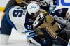 Morgan Barron&rsquo;s face hit the sake of Vegas goalie Laurent Brossoit during the first period on Tuesday. (John Locher / The Associated Press files)