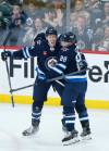 John Woods / THE CANADIAN PRESS files
                                Winnipeg Jets defenceman Logan Stanley (left) celebrates hid lone goal of the 2022-23 with Nate Schmidt. Stanley got his first taste of playoff action this season Monday night.